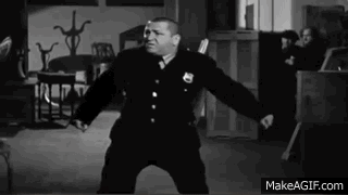 An animated .gif of Curly from the Three Stooges, lying on the floor on his side, running in a circle