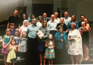 Everett's family posed at the front of his church. Cara is in the front, middle, holding baby Everett.