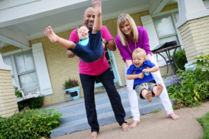 Another family pic. Vic is swinging Ev up and down between his leg, and Cara is doing the same with Liam.